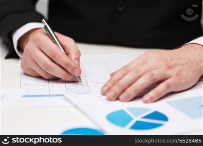 business and office concept - close up of businessman with papers