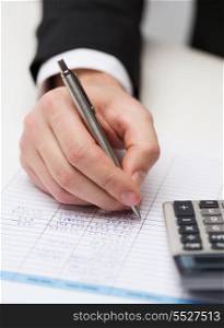business and office concept - close up of businessman with papers and calculator