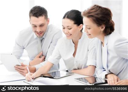 business and office concept - friendly business team with tablet pcs having discussion in office