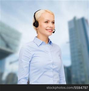business and office concept - friendly female helpline operator with headphones