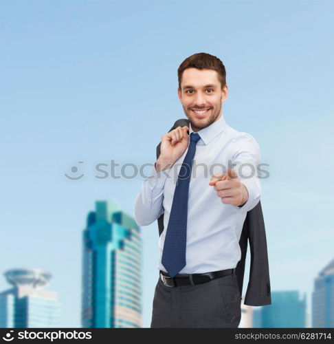 business and office concept - handsome buisnessman with jacket over shoulder pointing finger at you