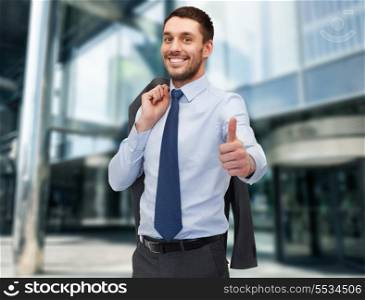 business and office concept - handsome buisnessman with jacket over shoulder showing thumbs up
