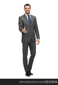 business and office concept - handsome buisnessman with open hand ready for handshake