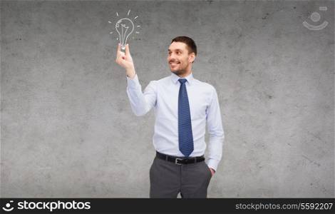 business and office concept - handsome businessman holding light bulb
