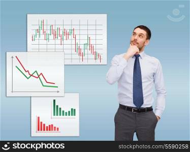business and office concept - handsome businessman looking up