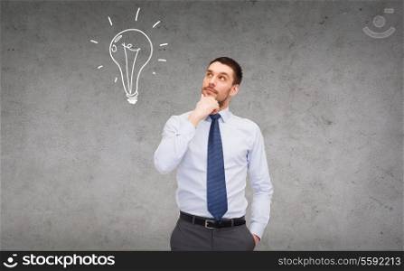 business and office concept - handsome businessman looking up