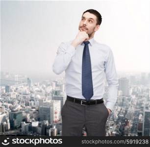 business and office concept - handsome businessman looking up. handsome businessman looking up