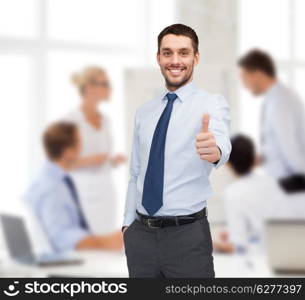 business and office concept - handsome businessman showing thumbs up