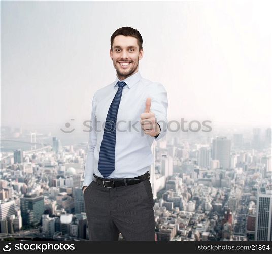 business and office concept - handsome businessman showing thumbs up. handsome businessman showing thumbs up