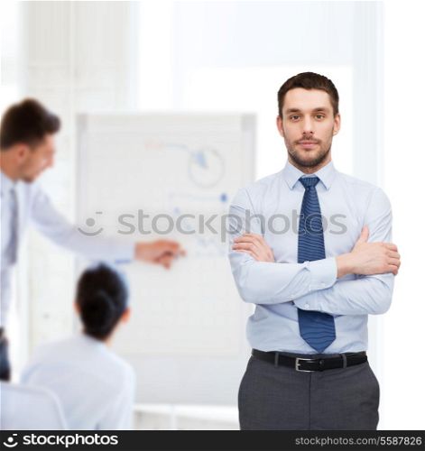 business and office concept - handsome businessman with crossed arms