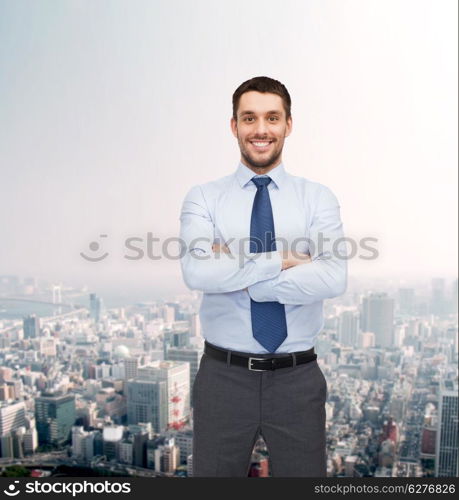 business and office concept - handsome businessman with crossed arms