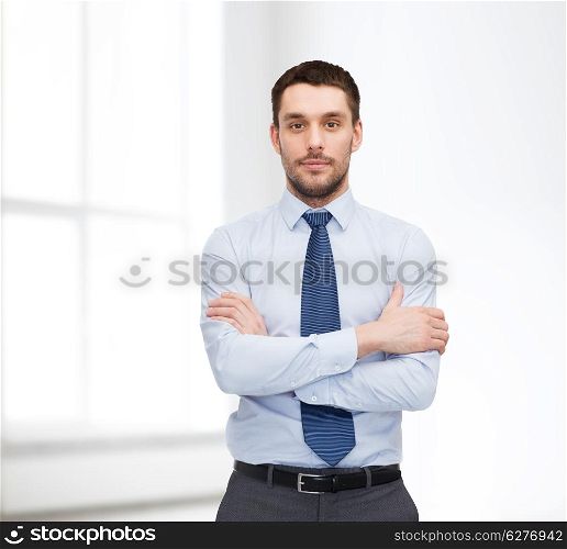 business and office concept - handsome businessman with crossed arms