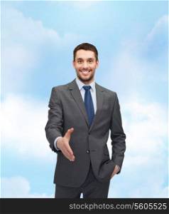 business and office concept - handsome businessman with open hand ready for handshake