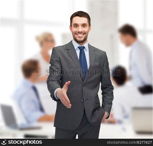 business and office concept - handsome businessman with open hand ready for handshake