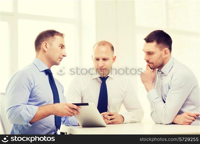 business and office concept - serious business team working with tablet pc computer in office