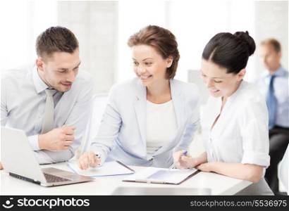 business and office concept - smiling business team discussing something in office