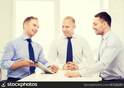 business and office concept - smiling business team working with tablet pc computer in office