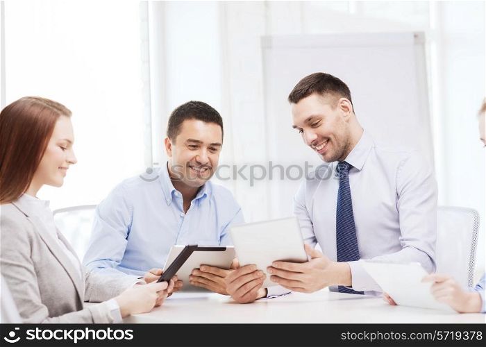 business and office concept - smiling business team working with tablet pc computers in office