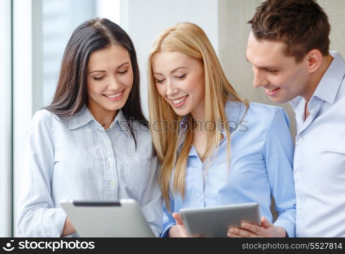 business and office concept - smiling business team working with tablet pcs in office