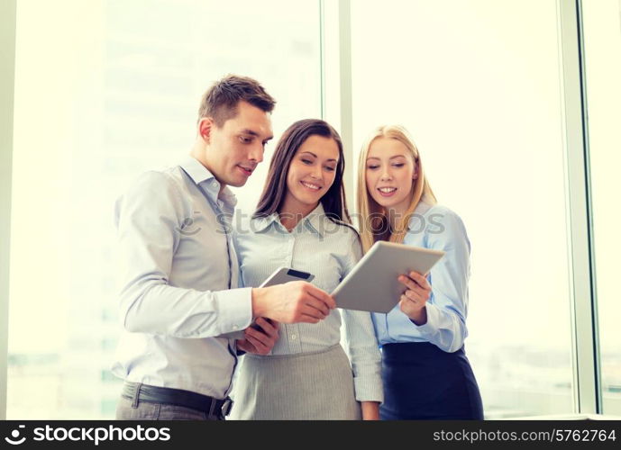 business and office concept - smiling business team working with tablet pcs in office