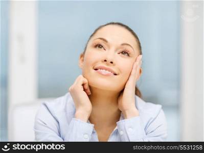 business and office concept - smiling businesswoman dreaming in office