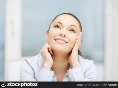 business and office concept - smiling businesswoman dreaming in office