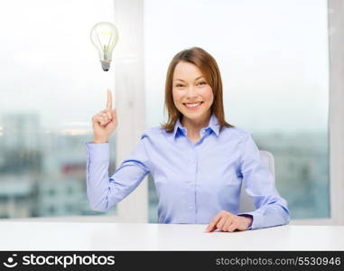 business and office concept - smiling businesswoman pointing finger up in office