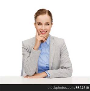 business and office concept - smiling businesswoman sitting at table