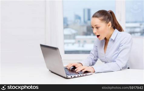 business and office concept - surprised businesswoman using her laptop computer. surprised businesswoman with laptop