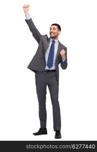 business and office concept - young happy businessman with hands up celebrating victory