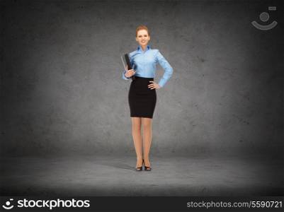 business and office concept - young smiling businesswoman with folder