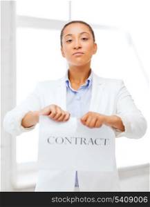 business and office, legal concept - african businesswoman tearing contract