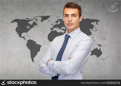 business and office, people concept - friendly young businessman with crossed arms