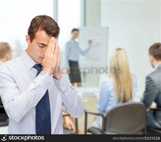 business and office, people concept - praying young buisnessman at office