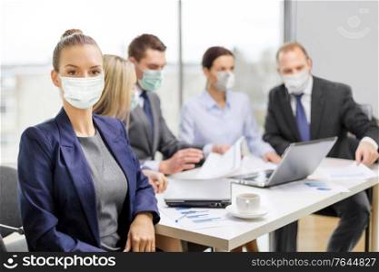 business and pandemic concept - businesswoman wearing face protective medical mask for protection from virus disease at office with team on the back. businesswoman in mask with colleagues at office