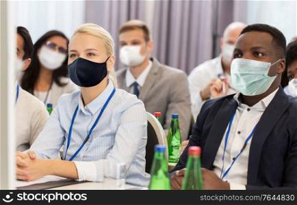 business and pandemic concept - group of people wearing face protective medical mask for protection from virus disease at international conference. business people in masks at worldwide conference