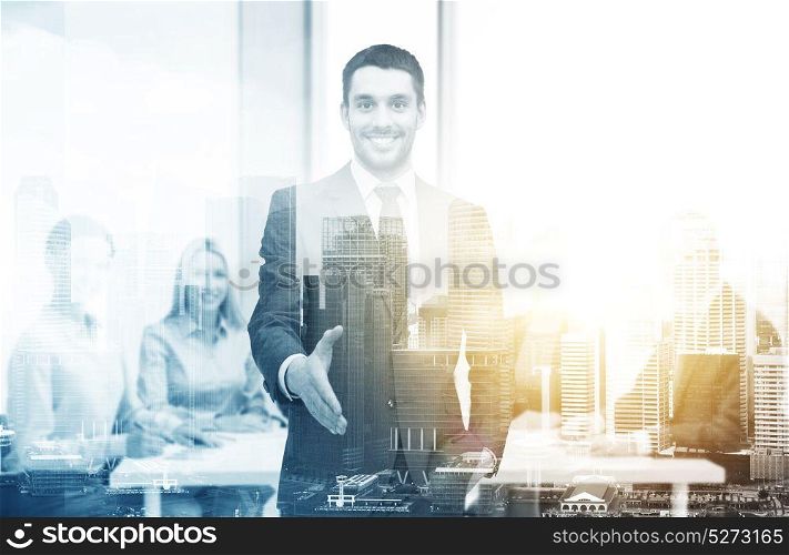 business and partnership concept - handsome businessman with open hand ready for handshake over city background and double exposure effect. businessman with open hand ready for handshake