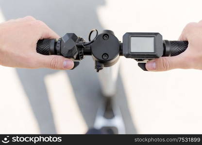 business and people and concept - close up of male hands holding to electric scooter wheel. close up of hands holding electric scooter wheel