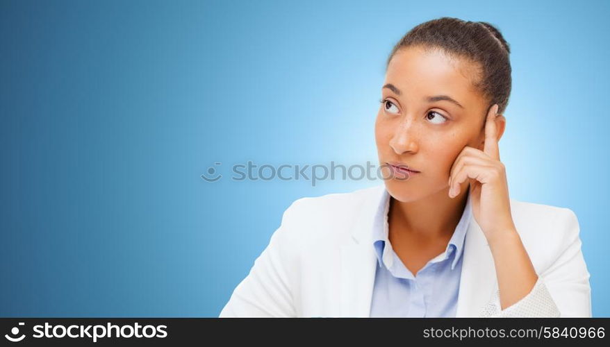 business and people concept - african american businesswoman looking up and thinking over blue background. african businesswoman looking up and thinking