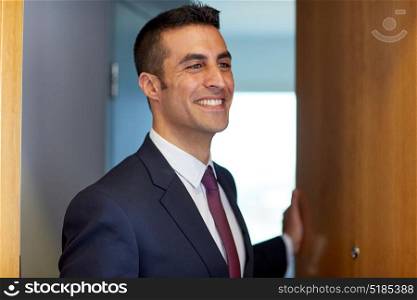 business and people concept - businessman at hotel room or office door. businessman at hotel room or office door
