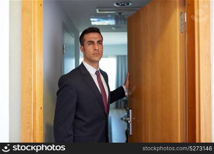 business and people concept - businessman at hotel room or office door. businessman at hotel room or office door