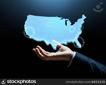 business and people concept - businessman hand with map of united states of america over dark background. hand with map of united states of america