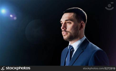 business and people concept - businessman in suit over black background. businessman in suit over black