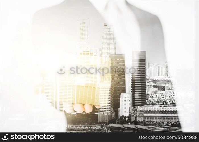 business and people concept - close up of businessman holding gift box over city with double exposure. close up of businessman holding gift box. close up of businessman holding gift box