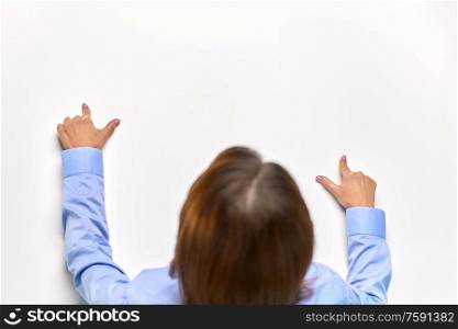 business and people concept - close up of businesswoman touching white board or table with fingers. businesswoman touching white table with fingers