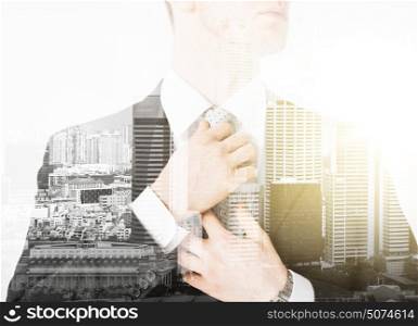 business and people concept - close up of man adjusting his tie over city with double exposure. close up of man adjusting his tie