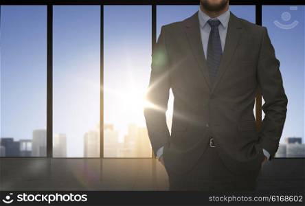 business and people concept - close up of of business man over office window background. close up of business man over office background