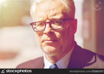 business and people concept - close up of senior businessman in eyeglasses and suit. close up of senior businessman in eyeglasses. close up of senior businessman in eyeglasses