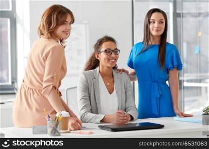 business and people concept - group of businesswomen at office. group of businesswomen at office. group of businesswomen at office