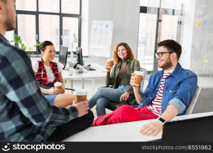 business and people concept - happy creative team drinking coffee at office. creative team drinking coffee at office. creative team drinking coffee at office